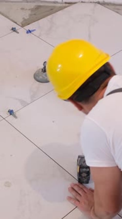 Tradesman Uses Laser Level to Lay Ceramic Tiles