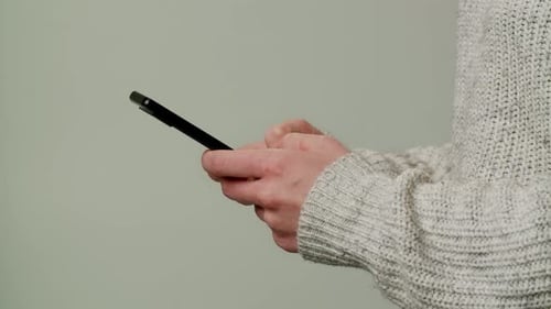 Close Up Smartphone in Caucasian Woman Hands Female Hands Typing Mobile Phone Isolated on Gray Color