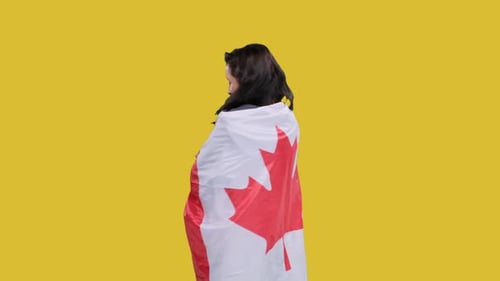 Woman Draped in Canadian Flag on Yellow Background