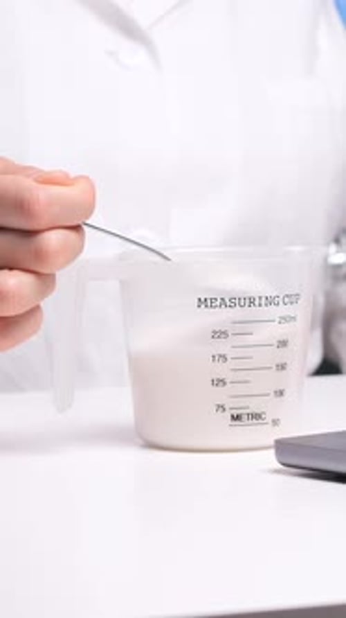 Vertical Video Close Up of Doctor Holding Spoon with Sugar in Hand Diabet