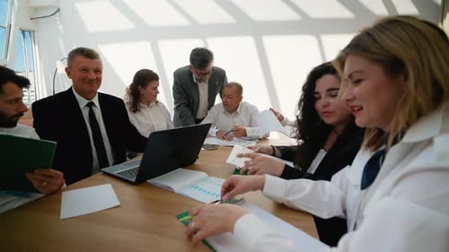Professional Business Team Collaborating During Corporate Meeting in Office