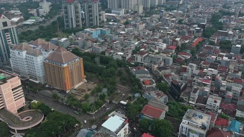 Aerial view flying over dense urban jakarta cityscape in indonesia
