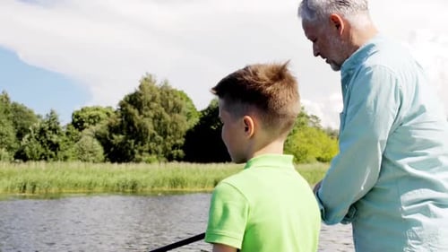 Grandfather and Grandson Fishing Together on Sunny Day