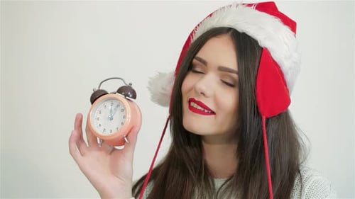 Woman in Santa Hat Shows Alarm Clock