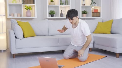 Man Doing Online Yoga Training At Home