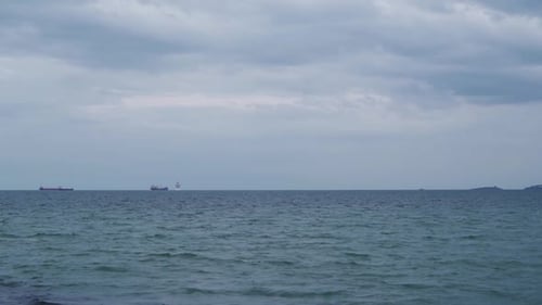 Cargo Ships in the Distance of the Ocean Horizon