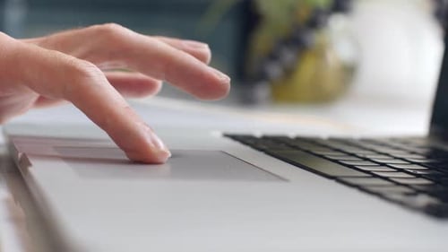 Close Up Person Using Laptop Touchpad at Desk