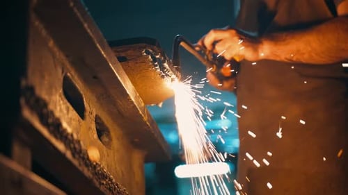 A Man Cuts Metal with a Gas Torch