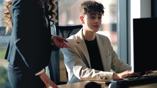 Young Adult Working with Mentor in Modern Office