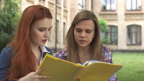 Two Students Laughing While Studying Together