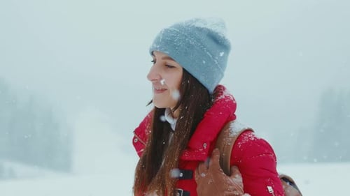 Smiling Young Beautiful Woman Stand Look at Camera in the Winter Snowy Forest Portrait Pretty Hat