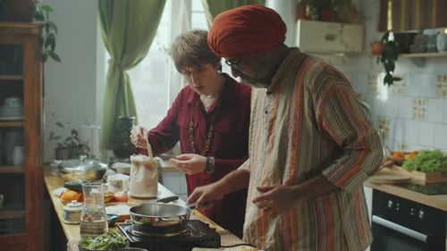 People Cooking Together in a Bright Kitchen