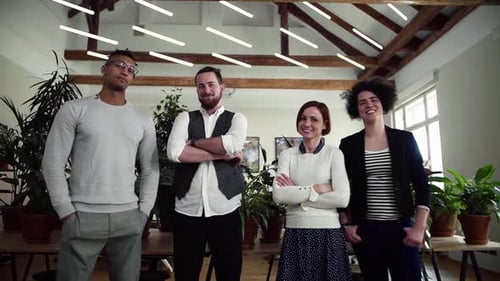 Young business team smiling together in a modern office building portrait