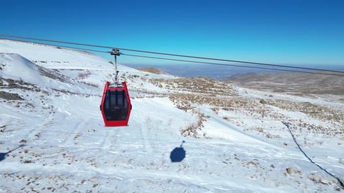 Gondolas carrying skiers to the top