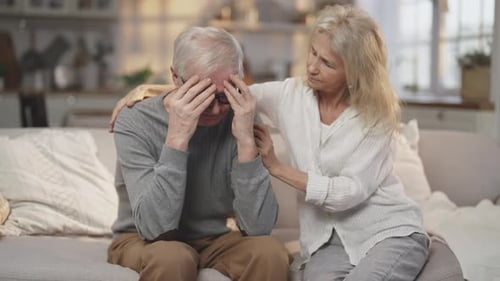 Mature Woman Comforting a Sad Senior Man