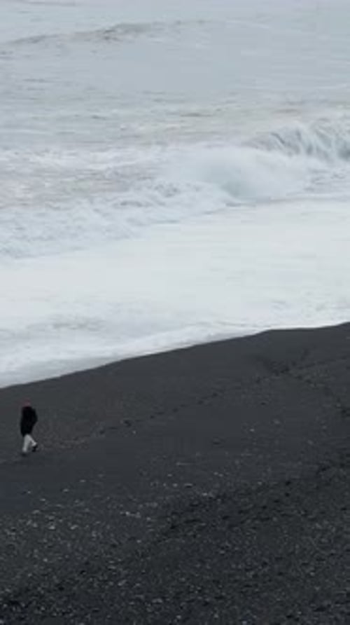 Icelandic Coastal Beauty Black Sand Beach Shown in Drone Footage Showcasing the Stunning Landscape