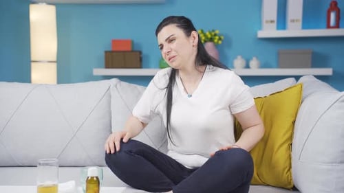 Woman experiencing pain in bones.