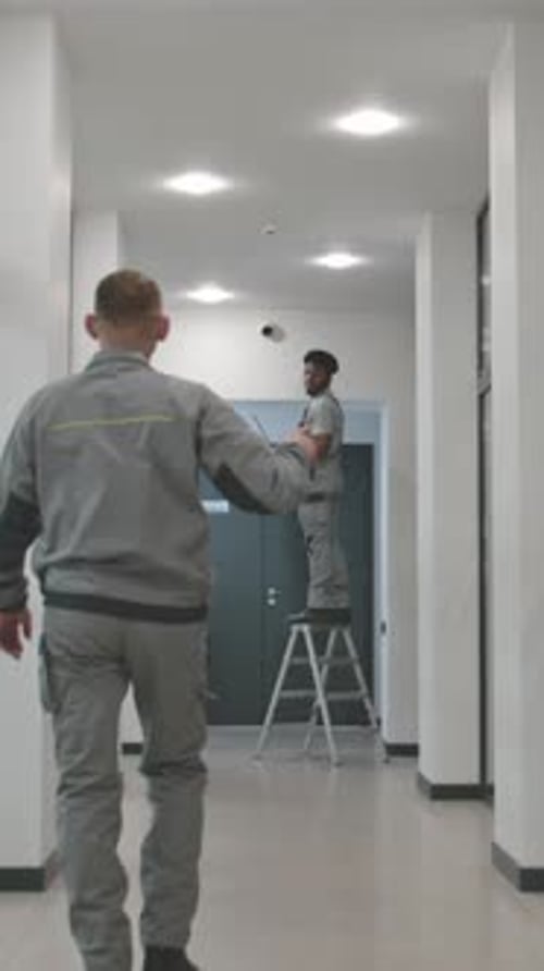 Technicians Install Security System in Modern Office