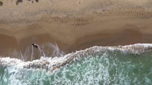 Aerial Slow Motion View of Remote Sandy Beach and Sea Waves by Drone