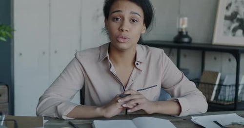 Portrait of Businesswoman Speaking and Looking at Camera Making Online Video Call From Office