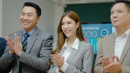 Close up group of businessman and woman clap hands together in office.