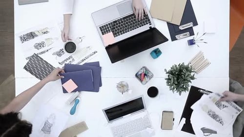 Fashion designers collaborating on the new clothing collection in the office