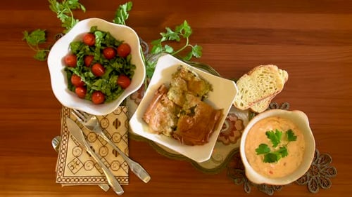 Healthy mediterranean cuisine, three dishes concept for lunch or dinner. Closeup of taking two plate