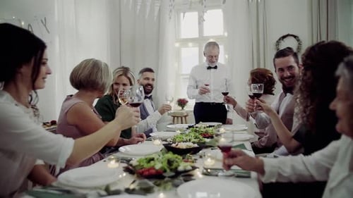 People Celebrating with Wine and Food at Dinner
