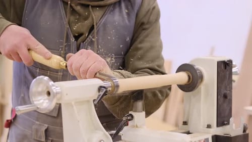 Close Up Carpenter at Workshop Polishes Wooden Board with a Electric Orbital Sander Woodwork and