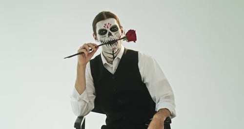 Person in Face Paint with Red Rose