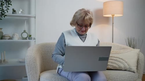 Senior Woman Using Laptop at Home