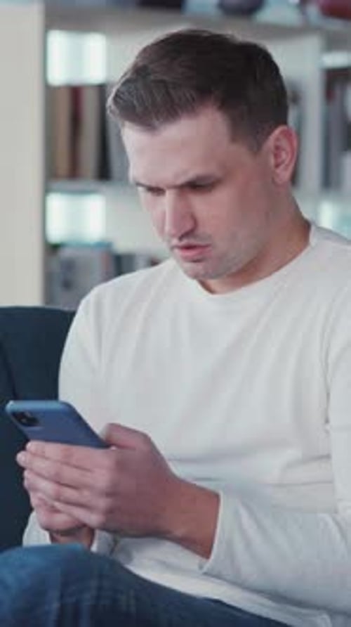 Man Using Phone Relaxing Indoors