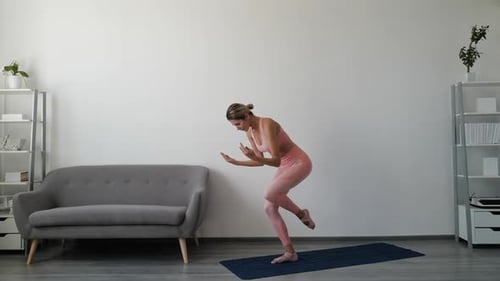 Woman Exercising and Balancing in Living Room