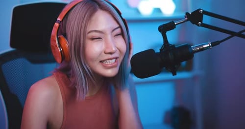 Young Adult Woman Speaking Into Microphone at Night