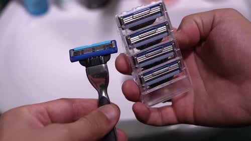 Gillette Mach 3 shaver and four blocks of spare cassettes for it on top view.