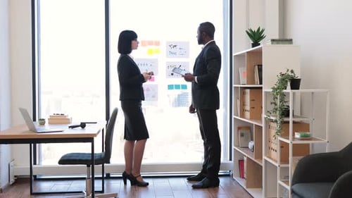 Business People Discussing Data in Bright Modern Office