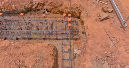 Installing Steel in a Trench for a House Foundation on a Construction Site As Part of the