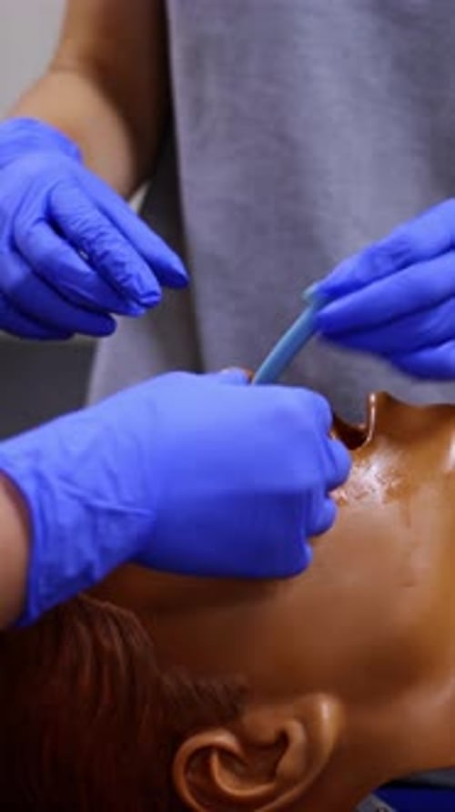 Training course in medical center. Medical instructing student to perform treatment procedure