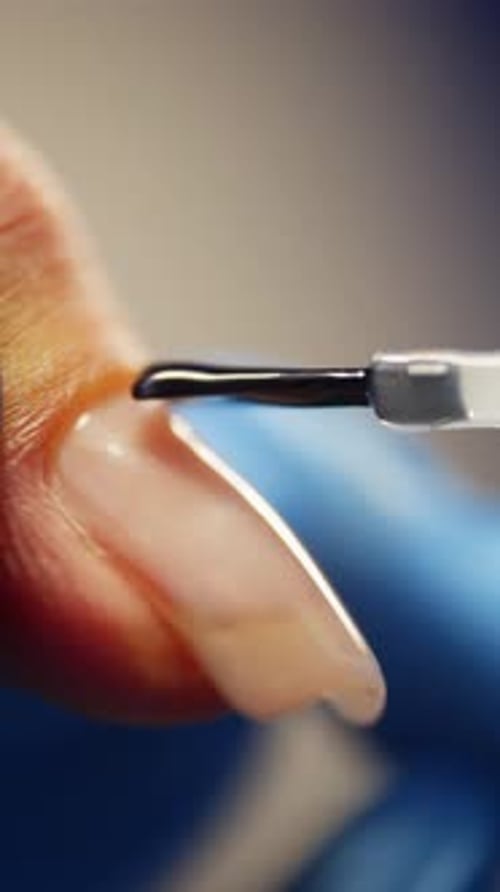 Applying a Thin Layer of Gel Base on the Nail Closeup