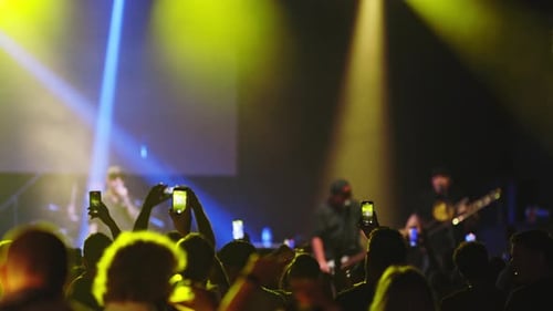 People Having Fun at the Rock Concert and Shooting the Show on Their Phone Cameras