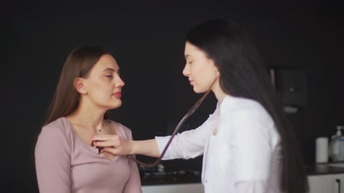 Female Doctor Examines Patient with Stethoscope