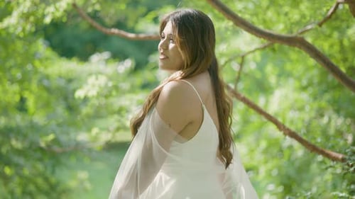 Woman in White Dress Twirling in Green Park