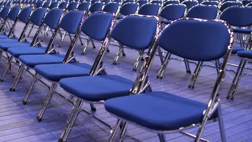 Rows of Empty Blue Chairs in Conference Room