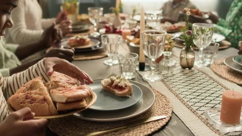People sharing bread at mealtime
