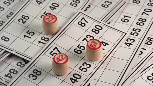 Bingo Cards with Wooden Number Barrels Close Up