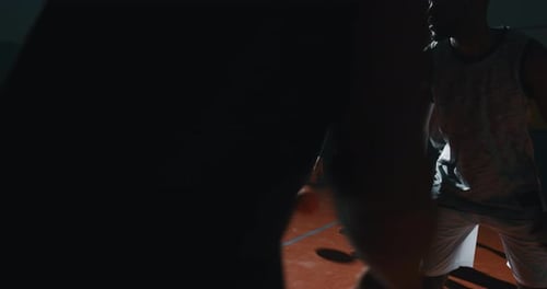 Cinematic slow motion close up shot of young professional male players are practicing a basketball