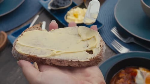 Spreading Butter on Bread Slice for Breakfast