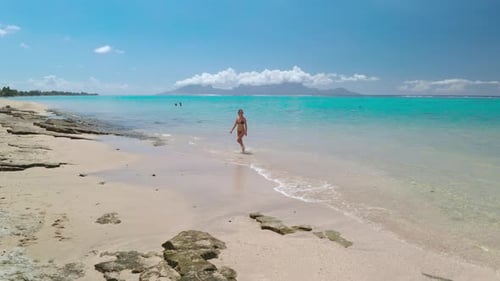Young Woman Walking on the Beach of a Tropical Island Paradise