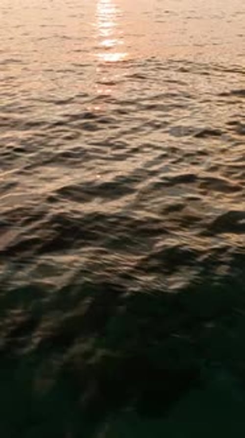 Vertical Video Coastal Sunset Serenade Aerial View of a Serene Sea Sunset