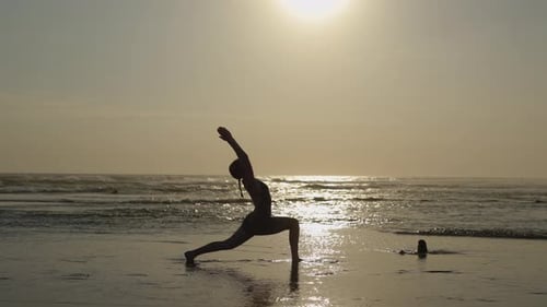 Woman Doing Yoga on Beach at Sunset